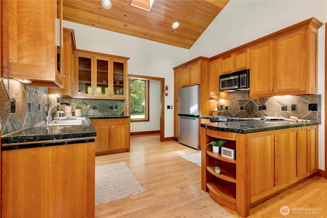 36915 NE 98th St, Carnation, WA 98014 - kitchen featuring appliances with stainless steel finishes, open shelves, a peninsula, vaulted ceiling, and tasteful backsplash