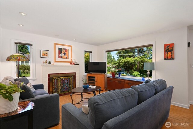 9539 49th Ave NE, Seattle, WA 98115 - living room featuring plenty of natural light, light wood finished floors, a brick fireplace, and recessed lighting