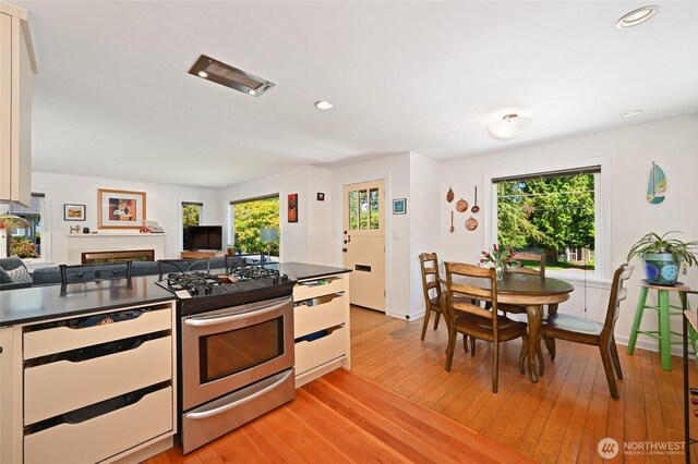 9539 49th Ave NE, Seattle, WA 98115 - kitchen featuring gas range, dark countertops, white cabinetry, dishwashing machine, and recessed lighting