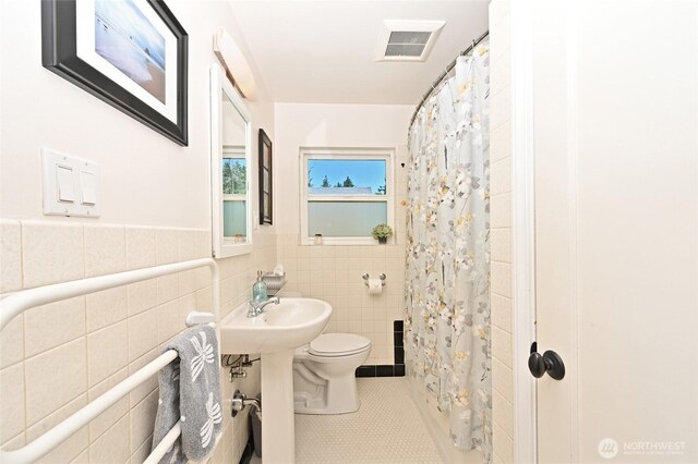 9539 49th Ave NE, Seattle, WA 98115 - full bathroom with tile walls, tile patterned floors, wainscoting, and curtained shower