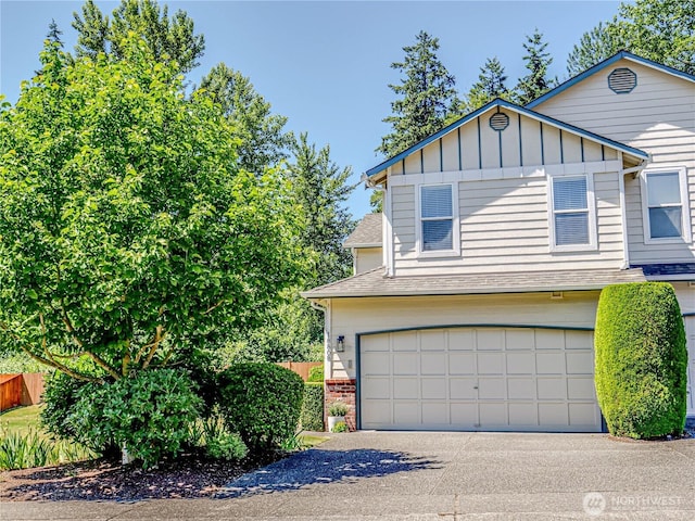18808 19th Dr SE, Bothell, WA 98012 - view of front facade with a garage, a shingled roof, driveway, board and batten siding, and brick siding