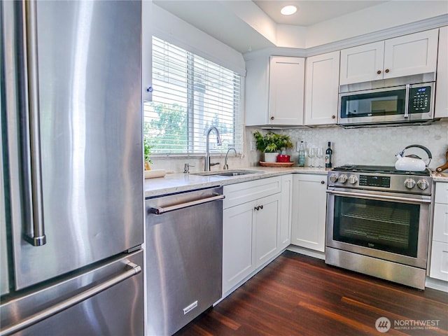 18808 19th Dr SE, Bothell, WA 98012 - kitchen featuring stainless steel appliances, decorative backsplash, dark wood finished floors, white cabinetry, and recessed lighting