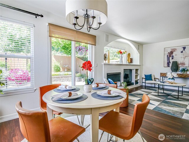 18808 19th Dr SE, Bothell, WA 98012 - dining area with healthy amount of natural light, wood finished floors, a glass covered fireplace, and a chandelier