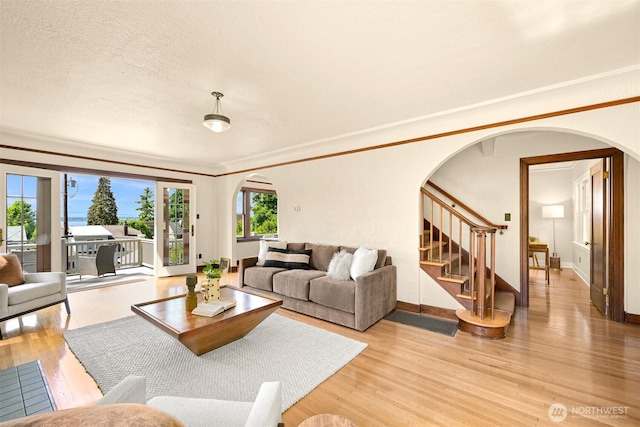 251 N Garden St, Bellingham, WA 98225 - living area with arched walkways, light wood-style flooring, stairs, and ornamental molding