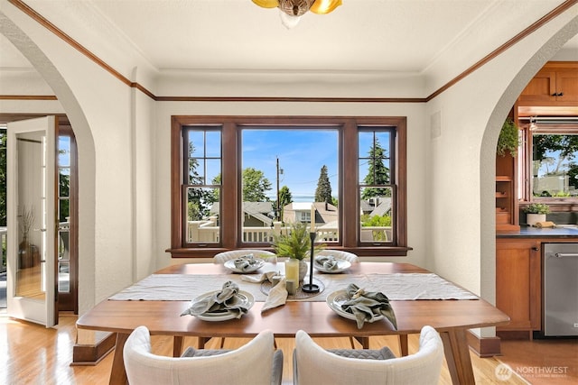 251 N Garden St, Bellingham, WA 98225 - dining room featuring arched walkways, healthy amount of natural light, light wood-type flooring, and crown molding