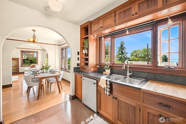 251 N Garden St, Bellingham, WA 98225 - kitchen with dishwasher, arched walkways, brown cabinetry, and light wood-style floors