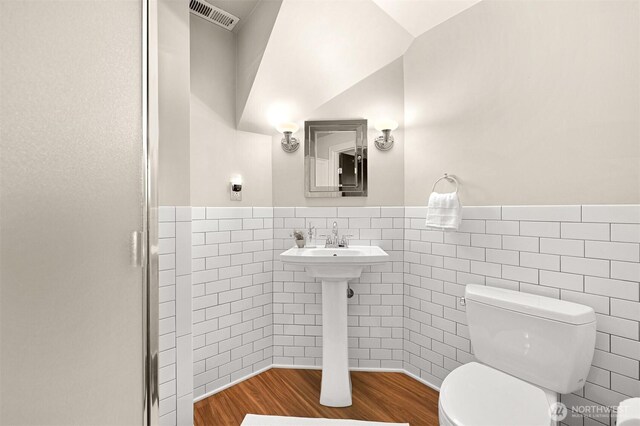 251 N Garden St, Bellingham, WA 98225 - bathroom featuring tile walls, wainscoting, wood finished floors, and an enclosed shower