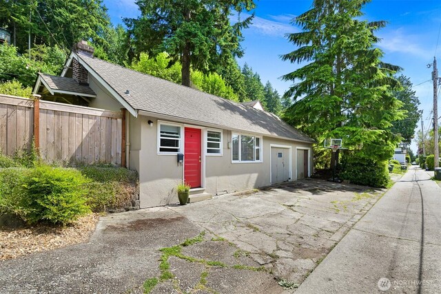 251 N Garden St, Bellingham, WA 98225 - view of front of house featuring stucco siding, an attached garage, driveway, and roof with shingles