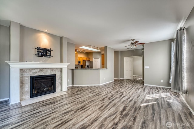 14413 Riverwalk Dr, Sumner, WA 98390 - unfurnished living room with wood finished floors, a ceiling fan, and a tile fireplace