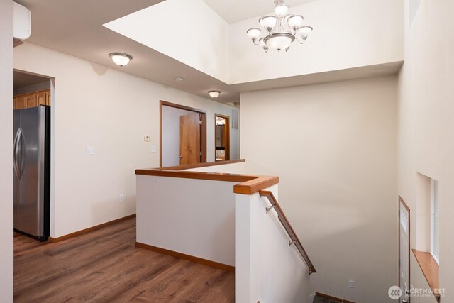 3706 54th St E, Tacoma, WA 98443 - staircase featuring wood finished floors, a chandelier, and a towering ceiling
