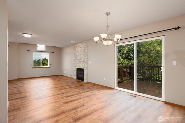 3706 54th St E, Tacoma, WA 98443 - unfurnished living room with wood finished floors, plenty of natural light, a chandelier, and a fireplace