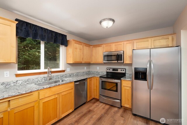 3706 54th St E, Tacoma, WA 98443 - kitchen featuring stainless steel appliances, light brown cabinets, light stone countertops, and light wood-type flooring