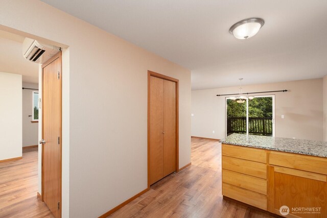 3706 54th St E, Tacoma, WA 98443 - corridor featuring light wood finished floors, a wall mounted air conditioner, and a chandelier