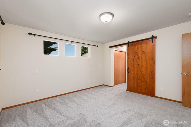 3706 54th St E, Tacoma, WA 98443 - unfurnished bedroom with carpet floors and a barn door