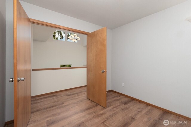 3706 54th St E, Tacoma, WA 98443 - spare room featuring wood finished floors and a chandelier