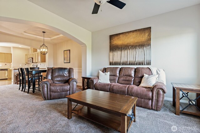 3031 Belmonte Ln, Everett, WA 98201 - living area with arched walkways, light carpet, a ceiling fan, and a raised ceiling