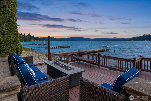 2819 E Lake Sammamish Pkwy NE, Sammamish, WA 98074 - deck at dusk featuring a fire pit, a boat dock, and a water and mountain view