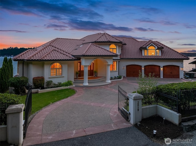 2819 E Lake Sammamish Pkwy NE, Sammamish, WA 98074 - mediterranean / spanish-style home with covered porch, driveway, a fenced front yard, and a tile roof