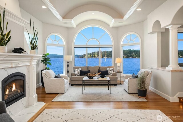 2819 E Lake Sammamish Pkwy NE, Sammamish, WA 98074 - living area with decorative columns, ornamental molding, wood-type flooring, a fireplace, and a water view