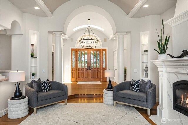 2819 E Lake Sammamish Pkwy NE, Sammamish, WA 98074 - foyer with wood finished floors, decorative columns, a high end fireplace, and recessed lighting