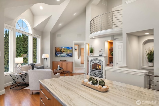 2819 E Lake Sammamish Pkwy NE, Sammamish, WA 98074 - dining room featuring wood finished floors, high vaulted ceiling, a warm lit fireplace, and recessed lighting