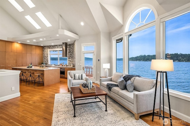 2819 E Lake Sammamish Pkwy NE, Sammamish, WA 98074 - living room with a skylight, a water view, light wood-style floors, and high vaulted ceiling