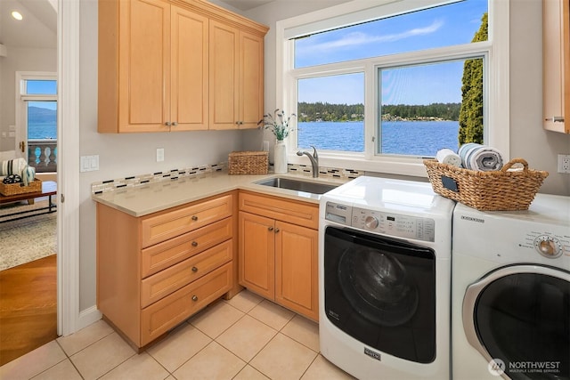 2819 E Lake Sammamish Pkwy NE, Sammamish, WA 98074 - washroom with cabinet space, separate washer and dryer, light tile patterned floors, recessed lighting, and a water view