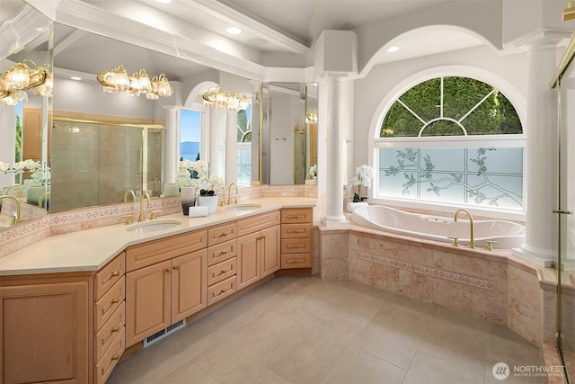 2819 E Lake Sammamish Pkwy NE, Sammamish, WA 98074 - bathroom with decorative columns, a stall shower, a garden tub, double vanity, and recessed lighting