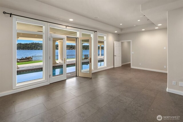2819 E Lake Sammamish Pkwy NE, Sammamish, WA 98074 - empty room with recessed lighting, dark tile patterned flooring, and a water view