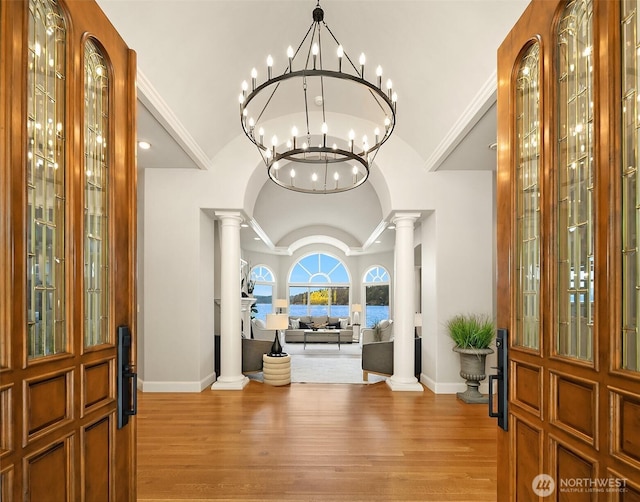 2819 E Lake Sammamish Pkwy NE, Sammamish, WA 98074 - entryway featuring vaulted ceiling, ornate columns, light wood-style floors, and a chandelier