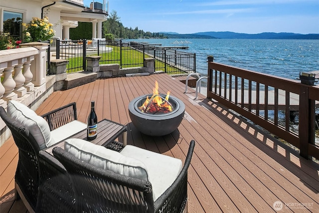 2819 E Lake Sammamish Pkwy NE, Sammamish, WA 98074 - deck with a water and mountain view and an outdoor living space with a fire pit
