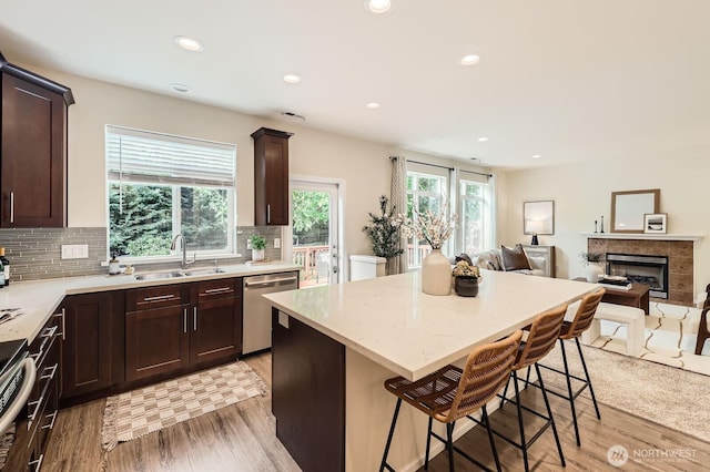 4015 134th Pl SE, Mill Creek, WA 98012 - kitchen featuring appliances with stainless steel finishes, open floor plan, dark brown cabinetry, light wood-style floors, and recessed lighting