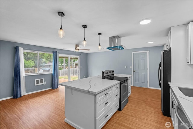 21318 125th St E, Bonney Lake, WA 98391 - kitchen with appliances with stainless steel finishes, island range hood, white cabinets, and a kitchen island