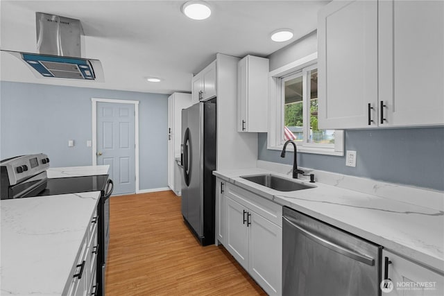 21318 125th St E, Bonney Lake, WA 98391 - kitchen with appliances with stainless steel finishes, light wood finished floors, white cabinetry, light stone countertops, and island exhaust hood