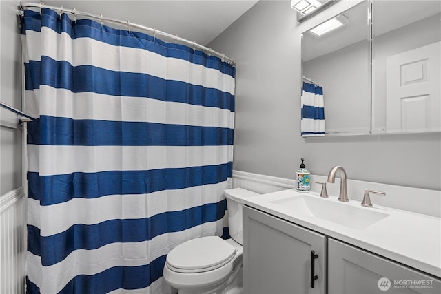 21318 125th St E, Bonney Lake, WA 98391 - bathroom featuring vanity, a shower with shower curtain, and wainscoting