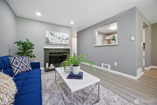 12906 8th Ave W Unit C102, Everett, WA 98204 - living area featuring wood finished floors, a brick fireplace, and recessed lighting