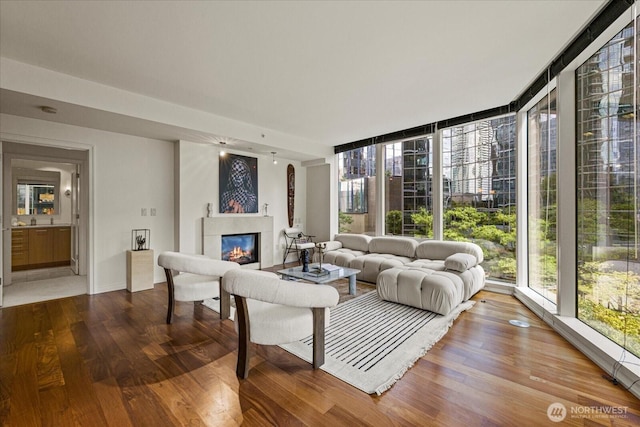 10700 NE 4th St Unit 712, Bellevue, WA 98004 - living area with a glass covered fireplace, wood finished floors, and expansive windows