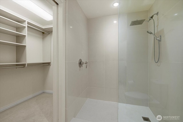 10700 NE 4th St Unit 712, Bellevue, WA 98004 - bathroom with tiled shower, recessed lighting, and a walk in closet