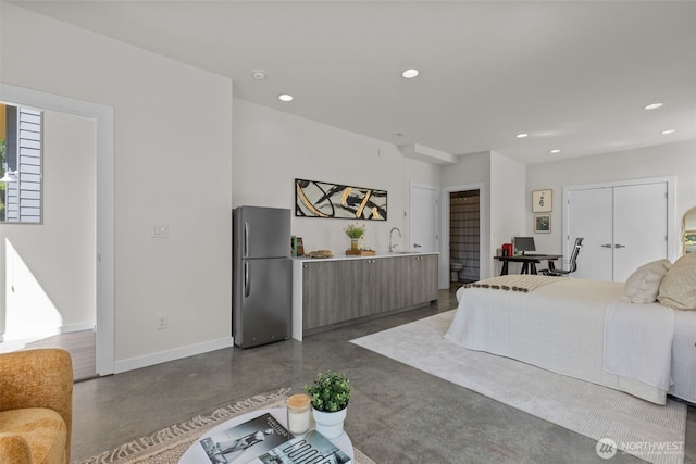 1100 14th Ave, Seattle, WA 98122 - bedroom featuring freestanding refrigerator, finished concrete floors, recessed lighting, and an office area