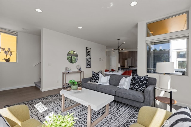1100 14th Ave, Seattle, WA 98122 - living area with wood finished floors, recessed lighting, stairs, plenty of natural light, and a chandelier