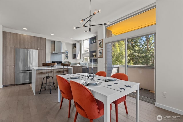 1100 14th Ave, Seattle, WA 98122 - dining room with healthy amount of natural light, light wood-type flooring, a chandelier, and recessed lighting