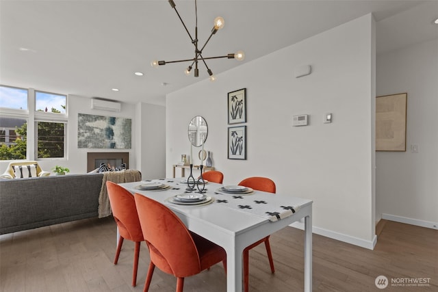 1100 14th Ave, Seattle, WA 98122 - dining area with an AC wall unit, wood finished floors, a chandelier, a lit fireplace, and recessed lighting