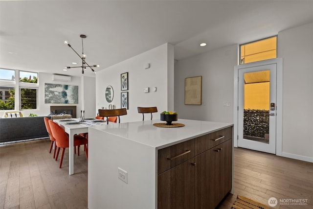 1100 14th Ave, Seattle, WA 98122 - kitchen featuring wood-type flooring, recessed lighting, a kitchen island, light countertops, and open floor plan