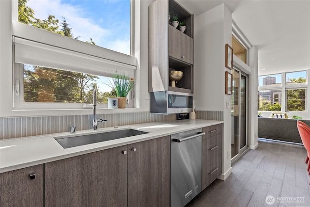 1100 14th Ave, Seattle, WA 98122 - kitchen featuring appliances with stainless steel finishes, light countertops, open shelves, dark brown cabinets, and dark wood-style floors