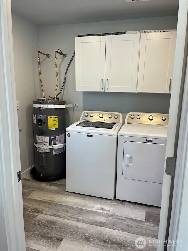 916 35th St, Anacortes, WA 98221 - laundry area featuring water heater, washer and dryer, cabinet space, and light wood finished floors
