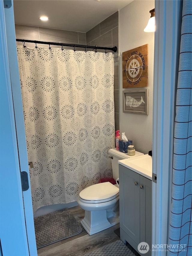 916 35th St, Anacortes, WA 98221 - bathroom with vanity, wood finished floors, and curtained shower