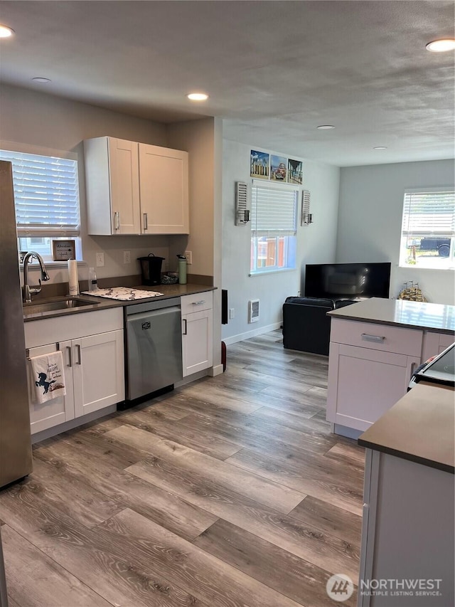 916 35th St, Anacortes, WA 98221 - kitchen featuring stainless steel appliances, recessed lighting, healthy amount of natural light, and wood finished floors