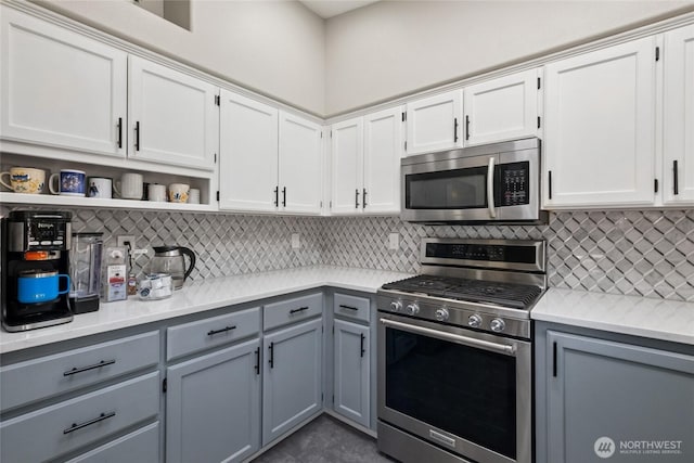 19204 112th St E, Bonney Lake, WA 98391 - kitchen with appliances with stainless steel finishes, gray cabinets, open shelves, light countertops, and decorative backsplash