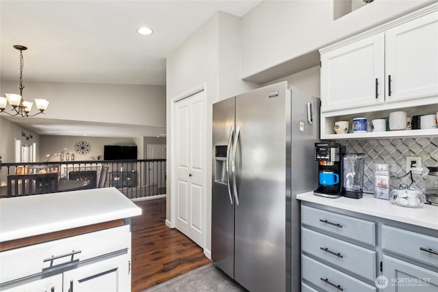 19204 112th St E, Bonney Lake, WA 98391 - kitchen featuring stainless steel fridge, a chandelier, decorative backsplash, light countertops, and white cabinetry
