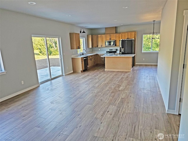 119 Davis View Dr, Centralia, WA 98531 - kitchen featuring stainless steel microwave, fridge with ice dispenser, light countertops, dishwashing machine, and light wood-style flooring